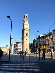 Fototapeta na wymiar Porto, Portugal - September 20 2019: Clérigos Tower with people going around. Clérigos Tower is a remarkable architectural complex located in the city of Porto.
