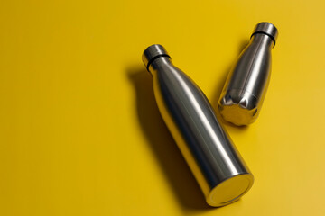Metal water bottle on color background. Zero waste. Space for text