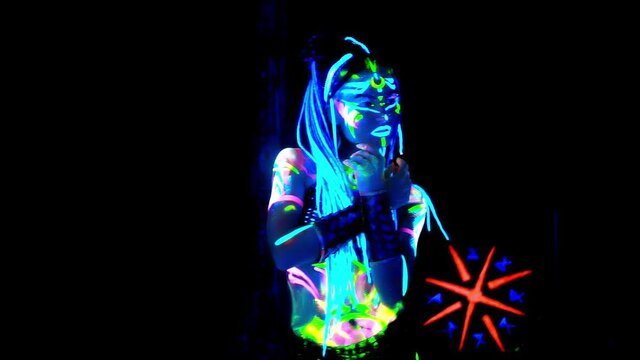 Portrait of woman which made of fluorescent paint in ultraviolet light.