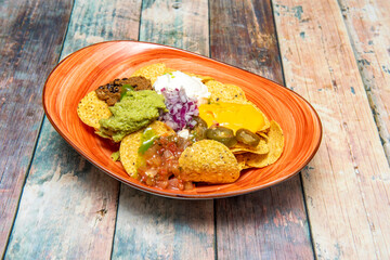 Red bowl full of Mexican corn nachos