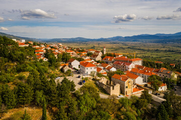 Fototapeta na wymiar Aerial view of Imotski, a small town in the Dalmatian hinterland with medieval Topana fortress and blue sky. Nature summer landscape, outdoor travel background, Dalmatia, Croatia. August 2020