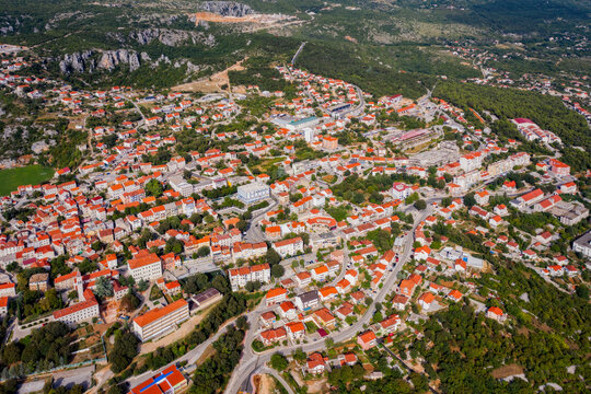 Aerial view of Imotski, a small town in the Dalmatian hinterland with medieval Topana fortress and blue sky. Nature summer landscape, outdoor travel background, Dalmatia, Croatia. August 2020