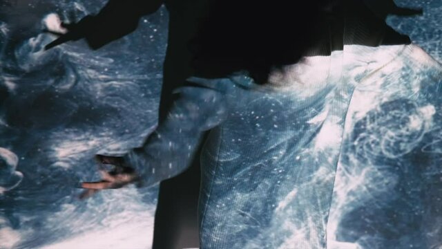 Space galaxy. Inspired woman. Transcendent energy. Trance meditation. Starry traveling. Silhouette dancing lady moving on blue white sparkle glowing cosmic spiral double exposure slow motion.