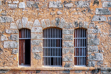 Fototapeta na wymiar Colonial stone wall and windows, Havana, Cuba