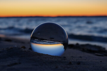 Fototapeta na wymiar glass ball on the beach