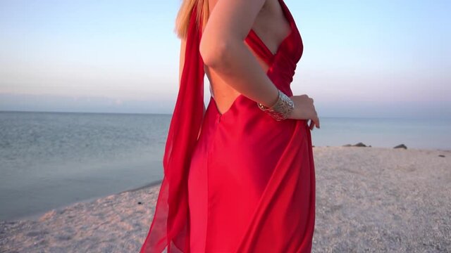 Slow Motion Young woman on a beach with red fabric