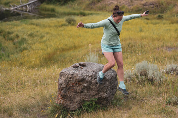 Woman Jumps Off of Boulder to Ground Below