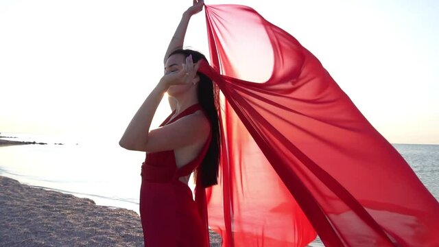 Slow Motion Woman in red dress windy weather