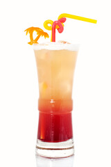 cocktail in a long glass with a palm tree