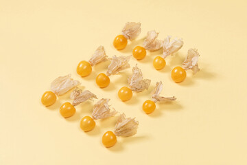 Cape Gooseberry isolated on yellow background. Clipping path.