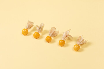 Cape Gooseberry isolated on yellow background. Clipping path.