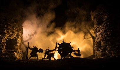 Medieval battle scene with cavalry and infantry. Silhouettes of figures as separate objects, fight between warriors on dark toned foggy background with medieval castle. - obrazy, fototapety, plakaty