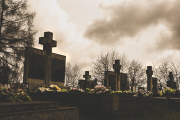 Gravestones on the cemetery.Clouds in background.High quality photo.