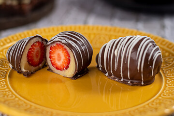 Dessert - chocolate bonbon stuffed with strawberry and chocolate brigadeiro