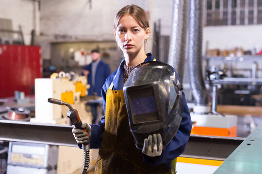 Portrait Of Female Welder In Factory Workshop. High Quality Photo