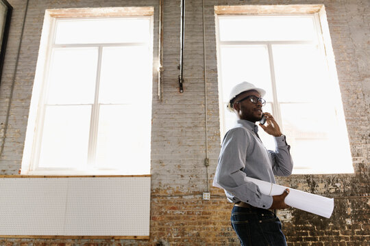 Young interior designer looking at new office space