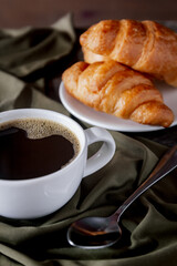 Croissants and coffee on the table in the morning