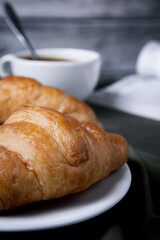 Croissants and coffee on the table in the morning