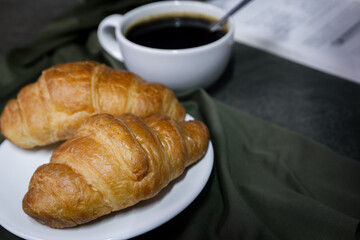 Croissants and coffee on the table in the morning
