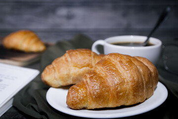 Croissants and coffee on the table in the morning