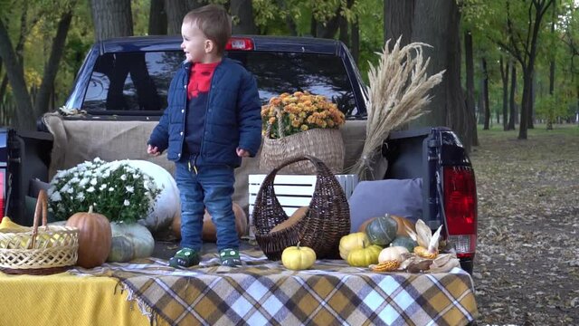 Family with pumpkin in autumn forest.