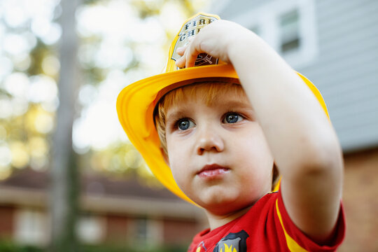 Young boy wearing fireman's helmet