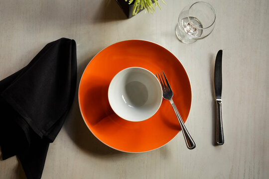 Empty plate among table setting - Powered by Adobe