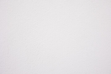 Close up and lay flat shot of concrete wall with white color painting shows texture and rough surface of material with bright and clean background. It is beautiful for blank background template.