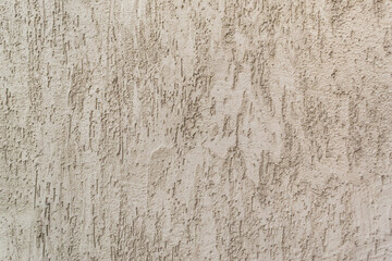 Background of gray one-color facade plaster. Single-layer cement monolithic plaster for decorative background. Exterior of the building facade covered with decorative gray textured plaster