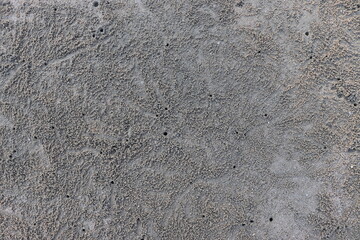 Sand on the seashore In Prachuap Khiri Khan Province, Thailand, the floor is wet and sticky. There are many holes. It is home to animals such as crabs and shellfish. Ideas for the background. Thailand
