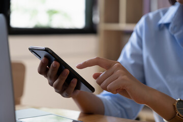 A businesswoman completes KYC using an online banking program in order to open a digital savings...