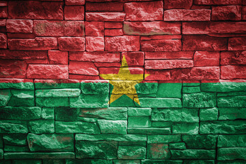 National flag of Burkino Faso on stone  wall background.The concept of national pride and symbol of the country. Flag  banner on  stone texture background.