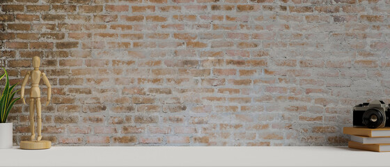 Contemporary working space with books, camera, wooden figure and copy space on the desk with brick wall, 3D rendering