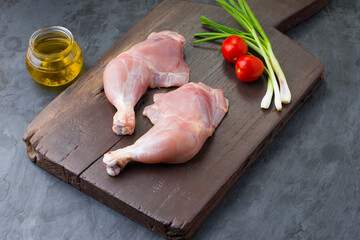 Raw whole chicken leg_grey board