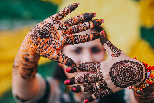 Bride showing mehndi tattoos design
