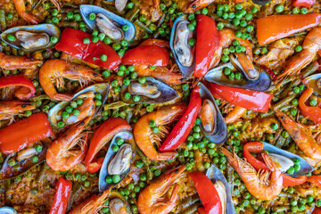 Spanish seafood paella in fry pan with mussels, shrimps and vegetables