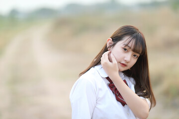 beautiful asian japanese school girl uniform looking at park outdoor