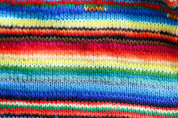 Colorful rainbow striped wool textile close up with colorful stripes