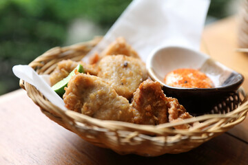Karaage Japanese fried chicken with lemon and sauce on wood background