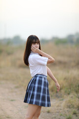 Fototapeta na wymiar beautiful asian japanese school girl uniform looking at park outdoor
