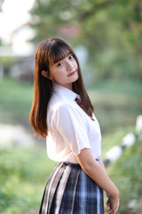 beautiful asian japanese school girl uniform looking at park outdoor