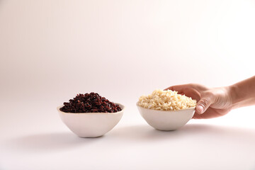 Organic boiled brown rice on bowl isolated in white background
