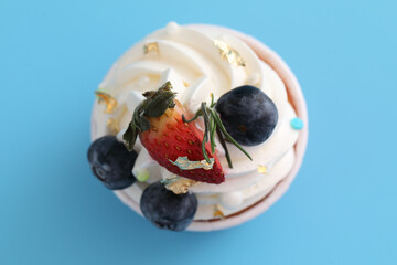 Fruits cupcake isolated in blue background