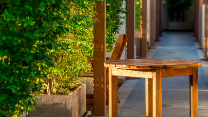 Fototapeta na wymiar A blurry abstract view of a walkway or a treadmill on the condo and a small garden surrounded, allowing guests to exercise or view the garden in the evening