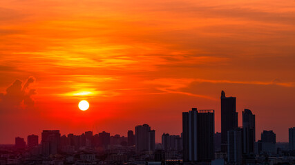 Fototapeta premium The high angle background of the city view with the secret light of the evening, blurring of night lights, showing the distribution of condominiums, dense homes in the capital community