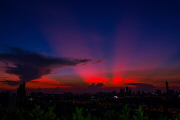 The high angle background of the city view with the secret light of the evening, blurring of night lights, showing the distribution of condominiums, dense homes in the capital community
