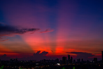 The high angle background of the city view with the secret light of the evening, blurring of night lights, showing the distribution of condominiums, dense homes in the capital community