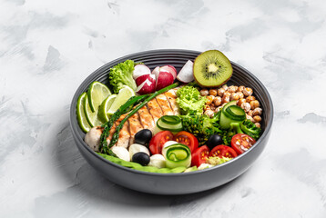 Buddha bowl dish with chicken fillet, avocado, asparagus, chickpeas, broccoli, radish, cucumber, tomatoes, olives, mozzarella. Healthy balanced eating. Top view