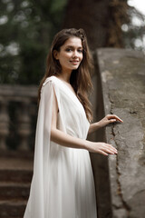 Wedding in an old villa in European style, trends 2021. The bride walks up the stairs of the villa overlooking the garden.