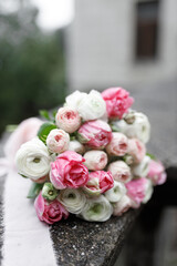 Wedding bouquet in the hands of the bride. A beautiful fresh bouquet of peonies and roses.